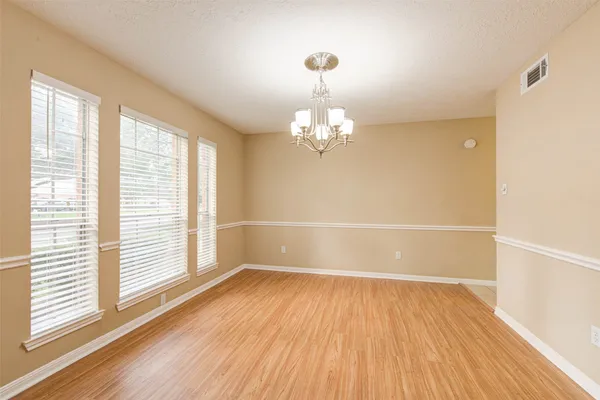 an entryway with wooden floor and mirror