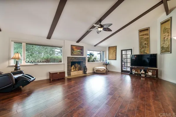 a living room with furniture window and a flat screen tv