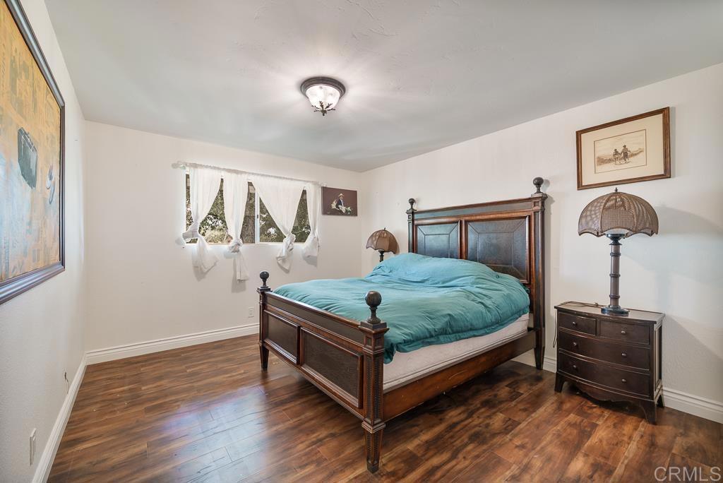 2719 Vía Del Robles Fallbrook, CA 92028 - Photo 23 of 48 a bedroom with a bed and a table