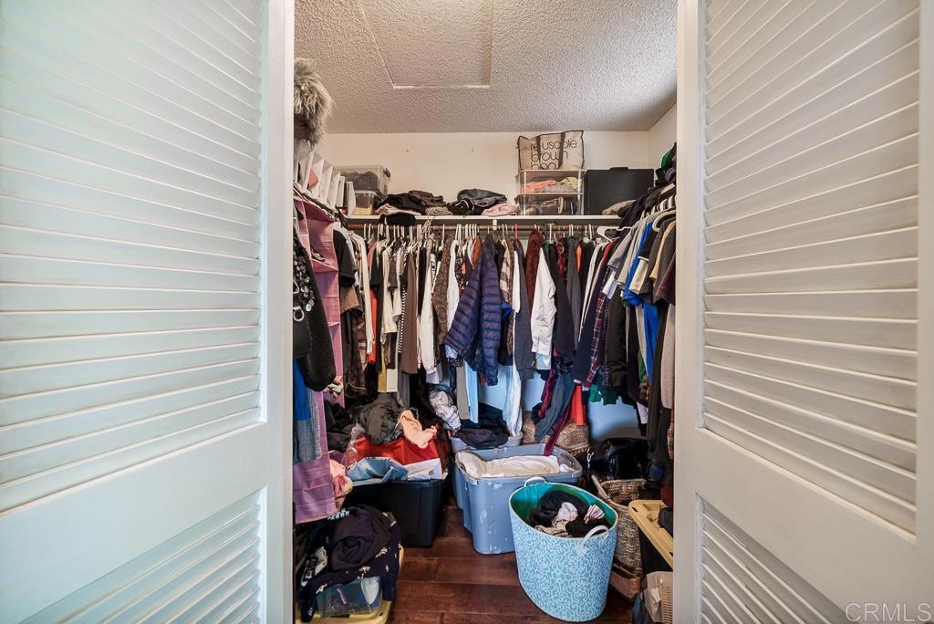 2719 Vía Del Robles Fallbrook, CA 92028 - Photo 29 of 48 a view of walk in closet with clothes and shoes