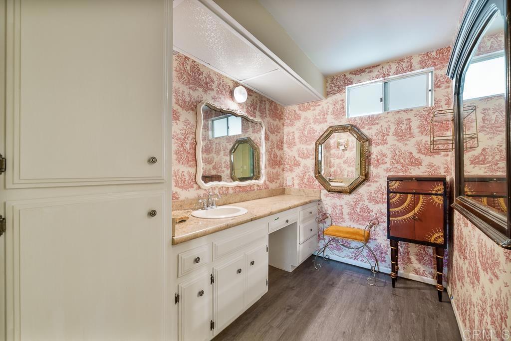 2719 Vía Del Robles Fallbrook, CA 92028 - Photo 30 of 48 a bathroom with a bathtub a mirror a sink and a large window