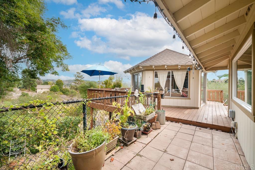 2719 Vía Del Robles Fallbrook, CA 92028 - Photo 33 of 48 a view of a patio with table and chairs and potted plants