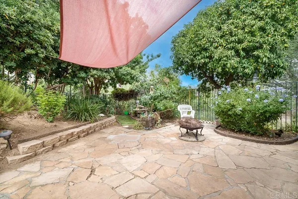 a view of a chair and table in backyard
