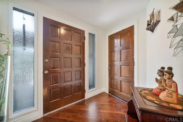 a room with wooden floor and furniture