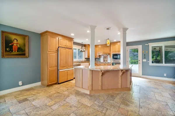 a large white kitchen with a large window