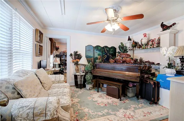 a living room with furniture a chandelier and a piano