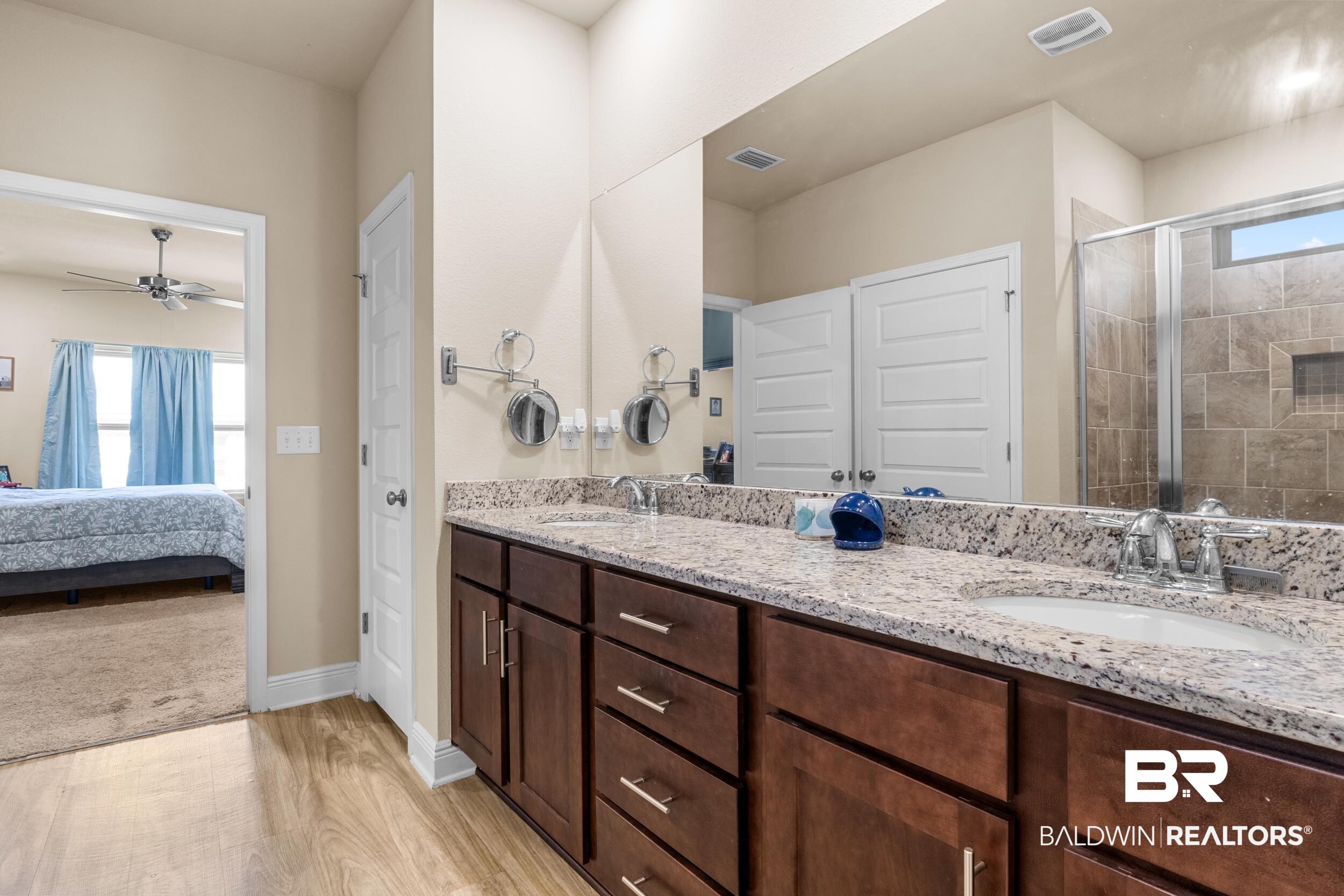 1431 Kairos Loop Foley, AL 36535 - Photo 16 of 27 Bathroom featuring ceiling fan, vanity, a shower with shower door, and hardwood / wood-style flooring