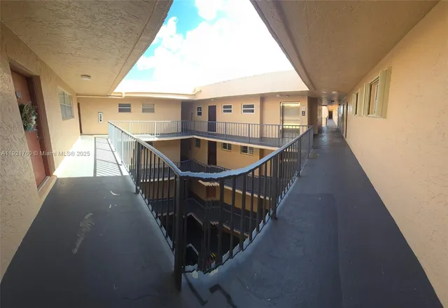 a view of balcony with wooden floor