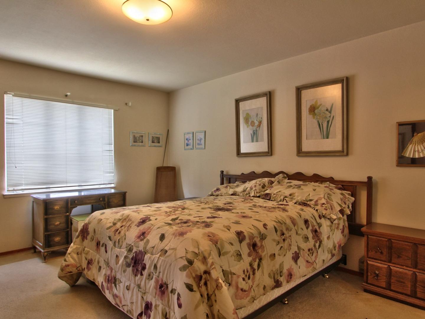 3220 Rio Road Carmel, CA 93923 - Photo 12 of 15 a bedroom with a bed and window