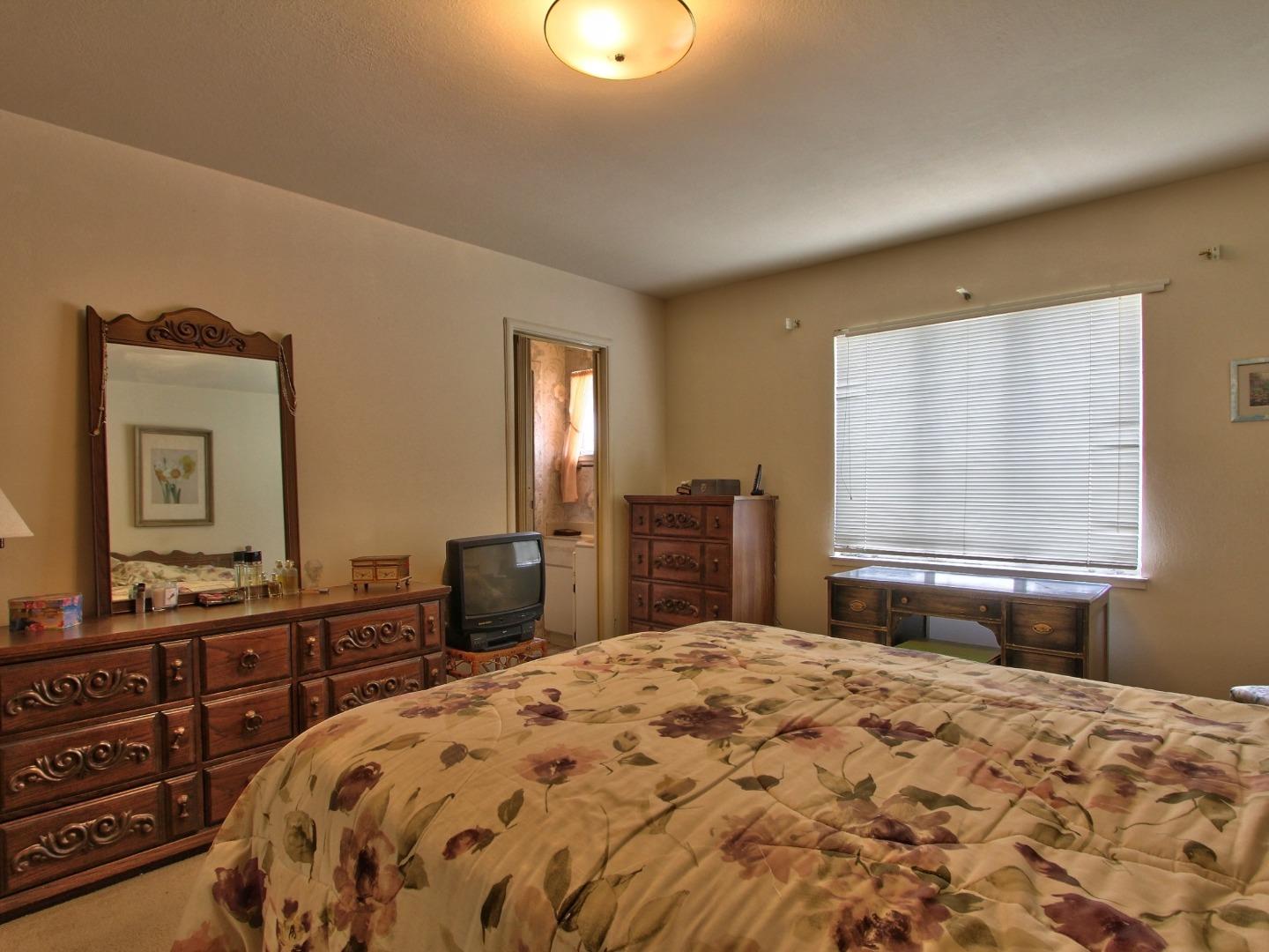 3220 Rio Road Carmel, CA 93923 - Photo 13 of 15 a bedroom with a bed and a dresser
