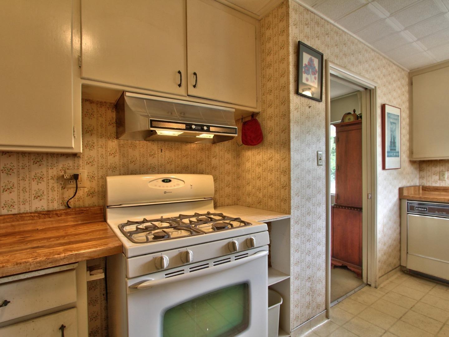 3220 Rio Road Carmel, CA 93923 - Photo 8 of 15 a kitchen with a stove and a refrigerator