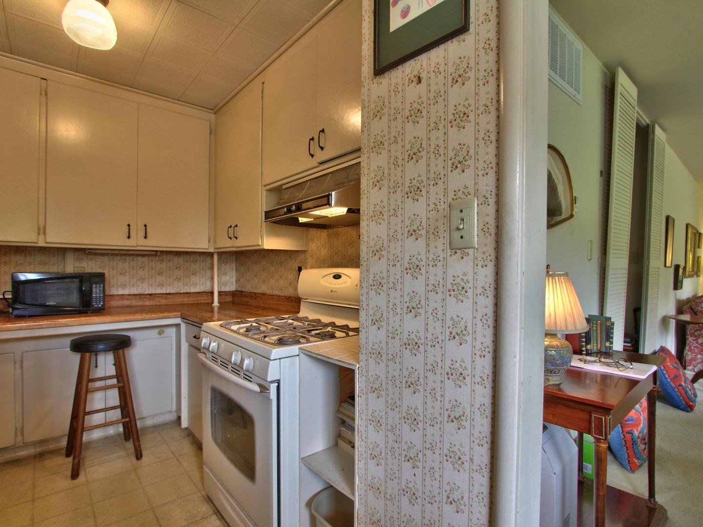 3220 Rio Road Carmel, CA 93923 - Photo 9 of 15 a kitchen with stainless steel appliances granite countertop a stove a sink and a refrigerator