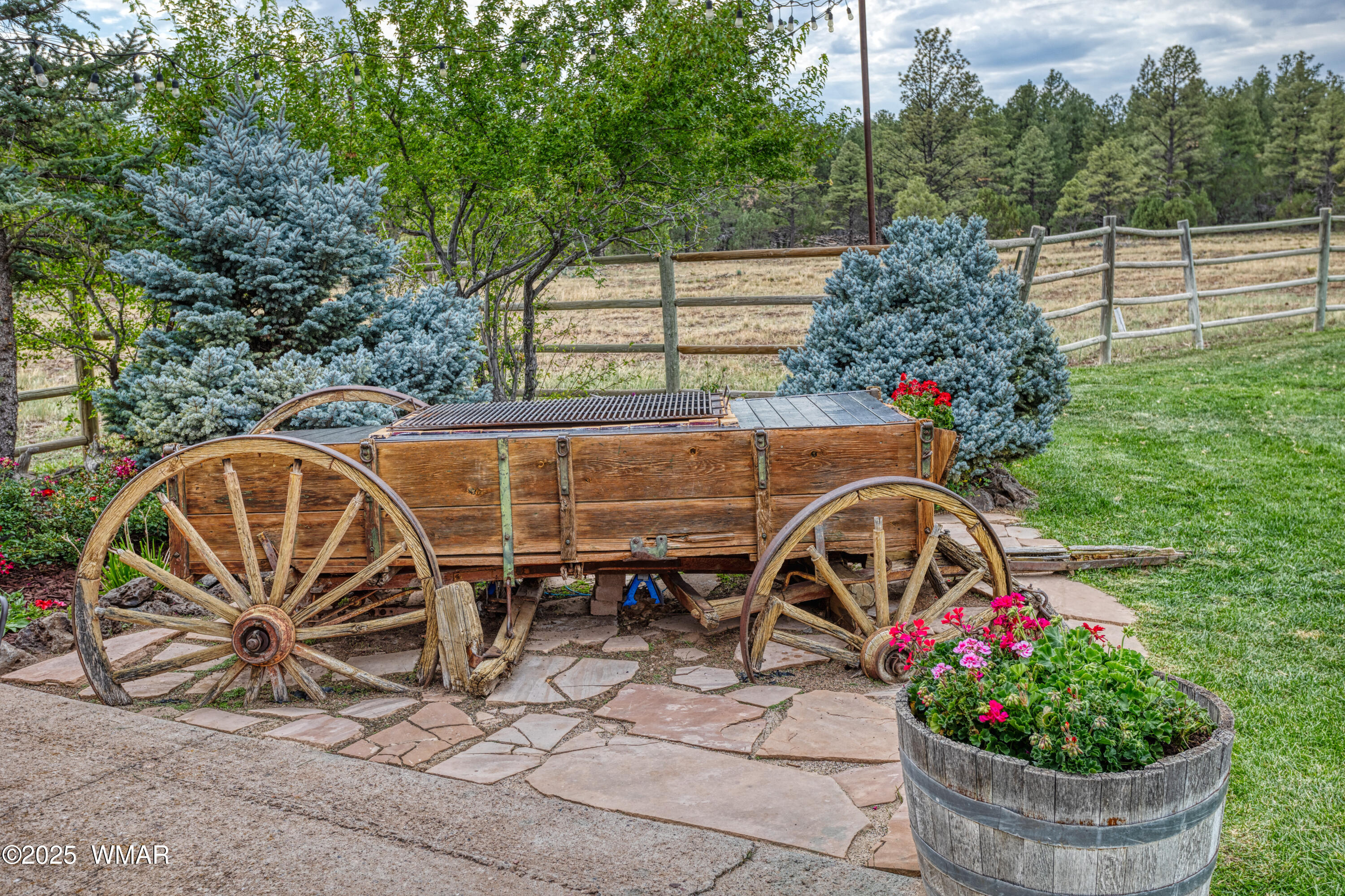 422 B Sponseller Siding Road Pinetop, AZ 85935 - Photo 11 of 74 a view of a backyard with table and chairs and potted plants