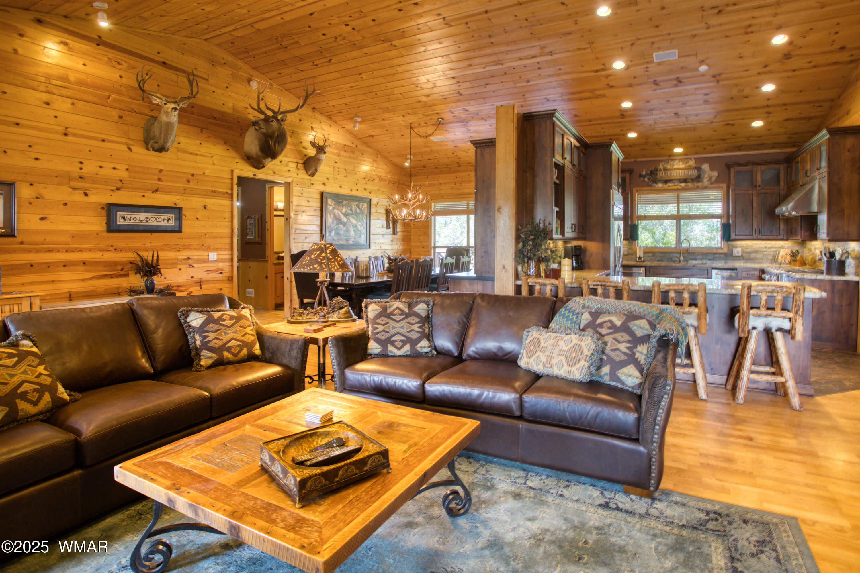 422 B Sponseller Siding Road Pinetop, AZ 85935 - Photo 19 of 74 a living room with furniture a rug and a chandelier