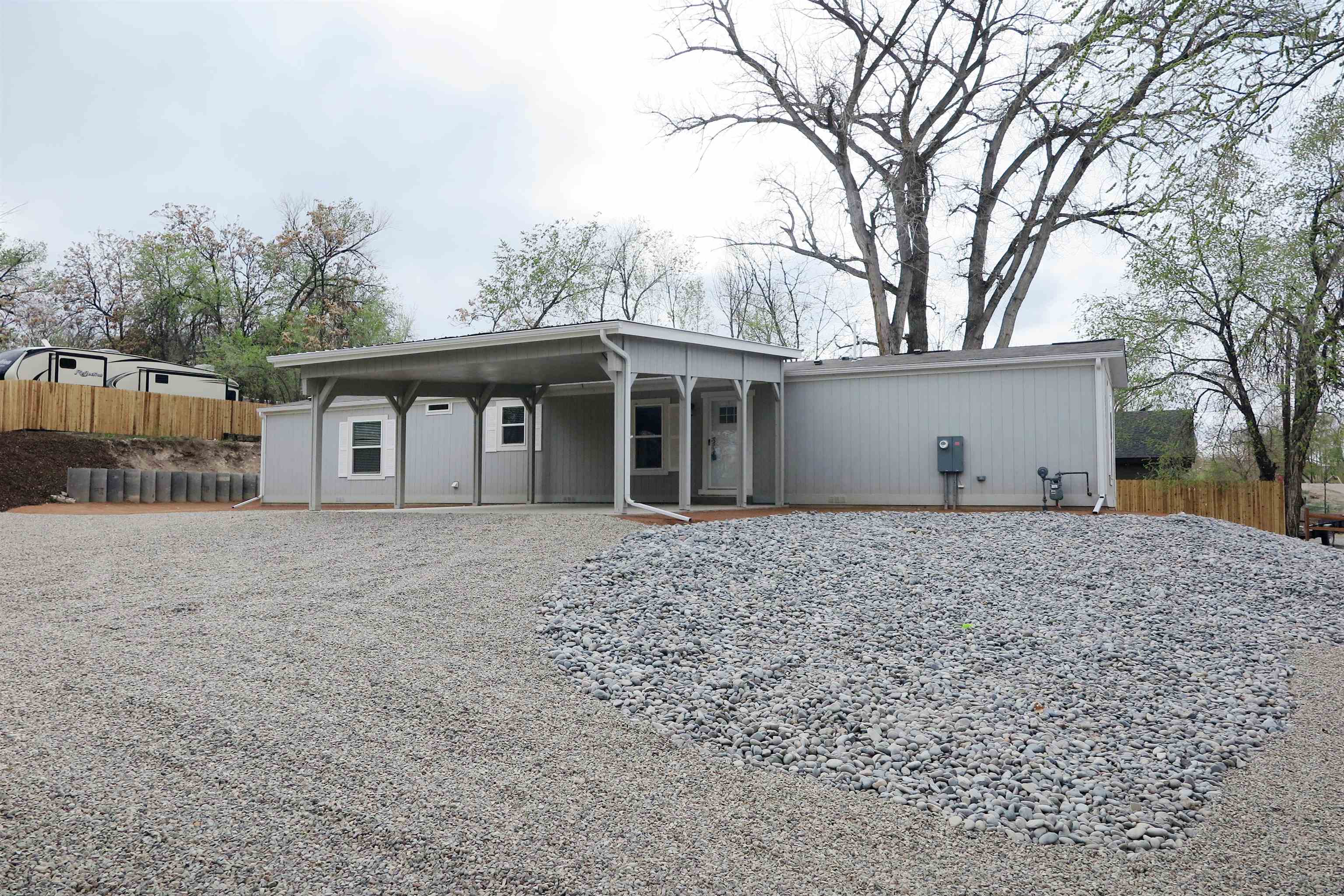 a view of a house with a yard and tree s