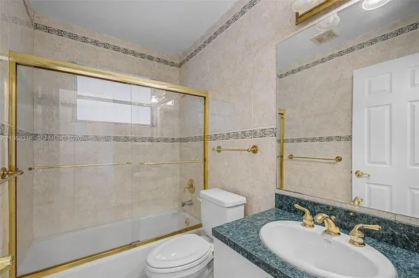a bathroom with a sink a toilet and bathtub