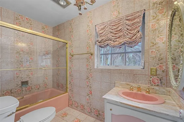 a bath room with a toilet and a shower curtain