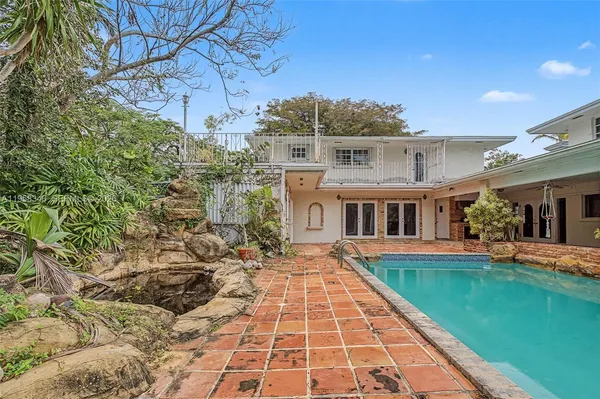 a view of a house with a tree in the background