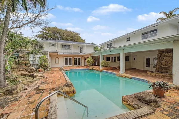 a view of backyard of house with green space