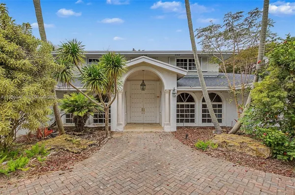 a front view of a house with a garden