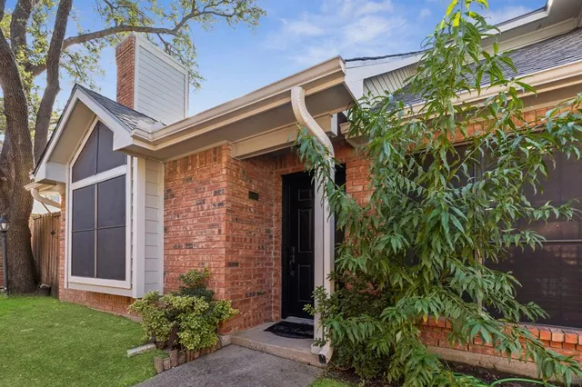front view of a house with potted plants