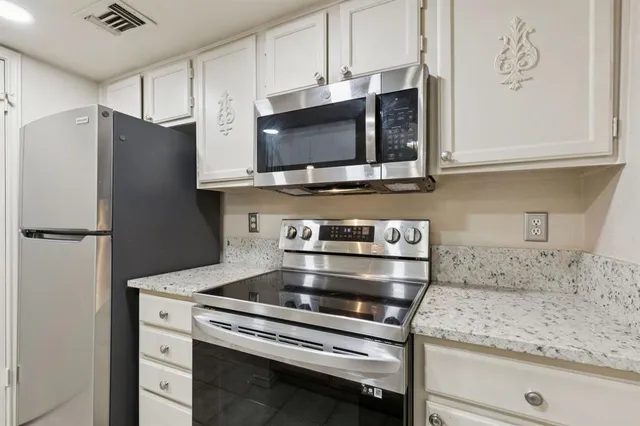 a kitchen with appliances and cabinets