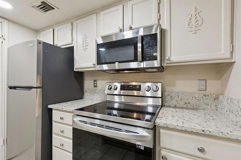 449 Harris Street, Unit 103B Coppell, TX 75019 - Photo 12 of 26 a kitchen with appliances and cabinets