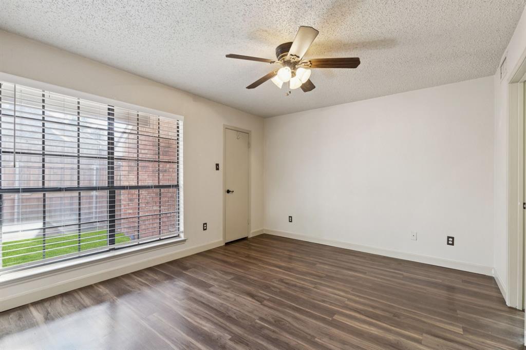 449 Harris Street, Unit 103B Coppell, TX 75019 - Photo 13 of 26 a view of an empty room with wooden floor and a window