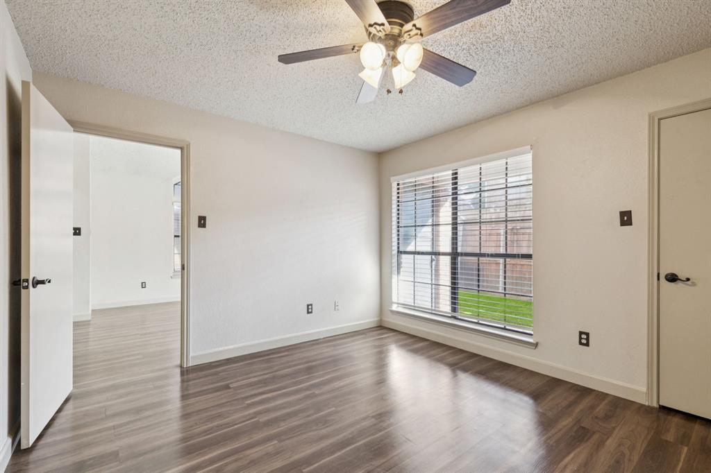 449 Harris Street, Unit 103B Coppell, TX 75019 - Photo 14 of 26 wooden floor in an empty room with a window