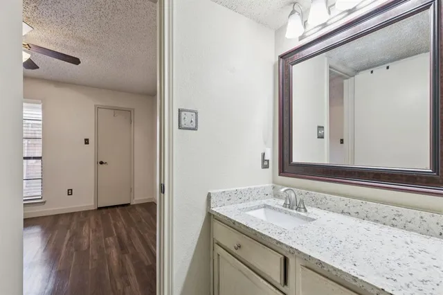 a view of bathroom with a sink and mirror