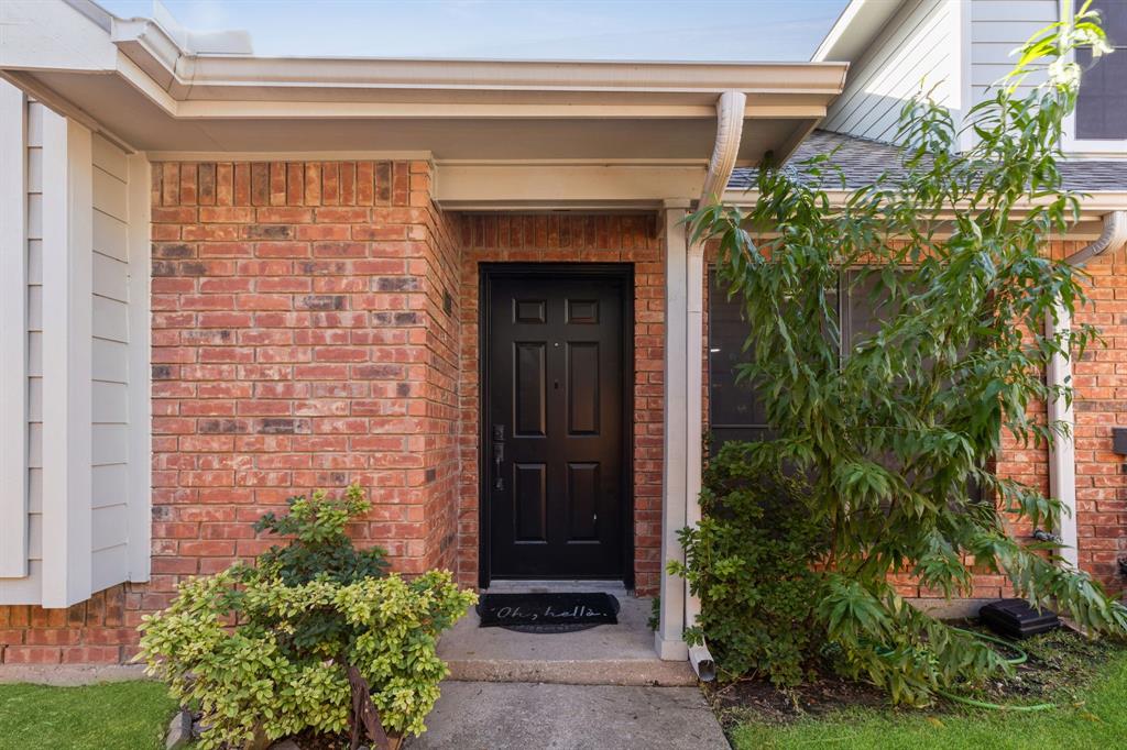 449 Harris Street, Unit 103B Coppell, TX 75019 - Photo 2 of 26 a front view of a house with garden