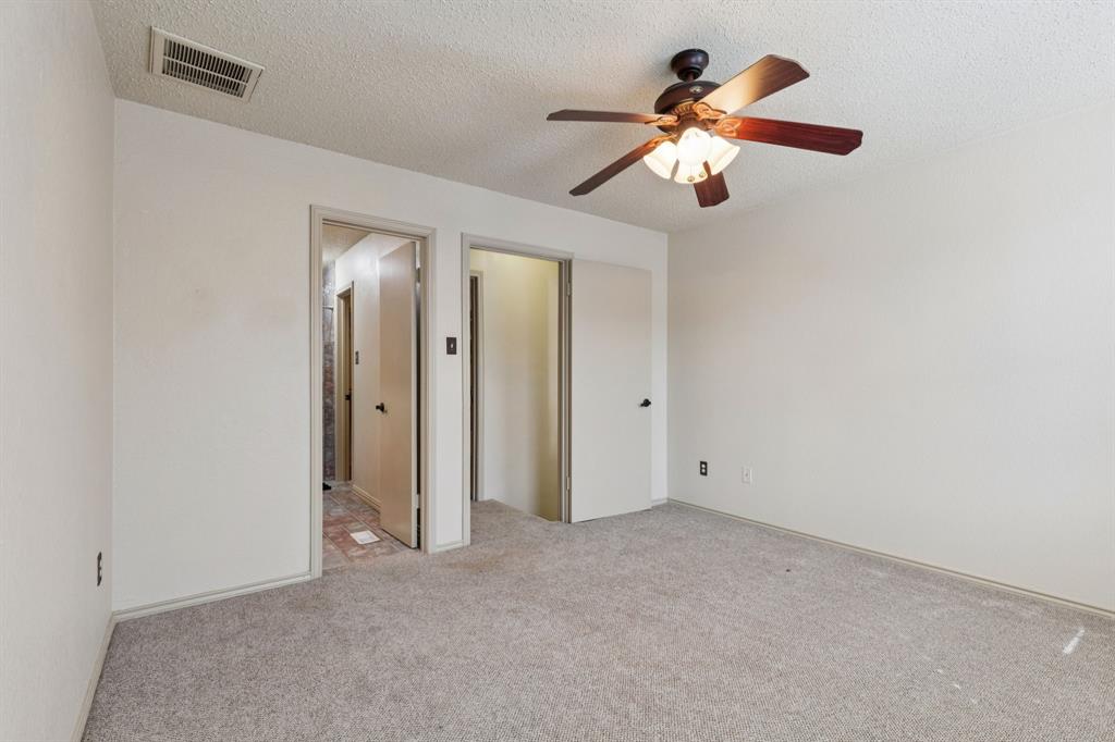 449 Harris Street, Unit 103B Coppell, TX 75019 - Photo 21 of 26 a view of an empty room with a chandelier fan
