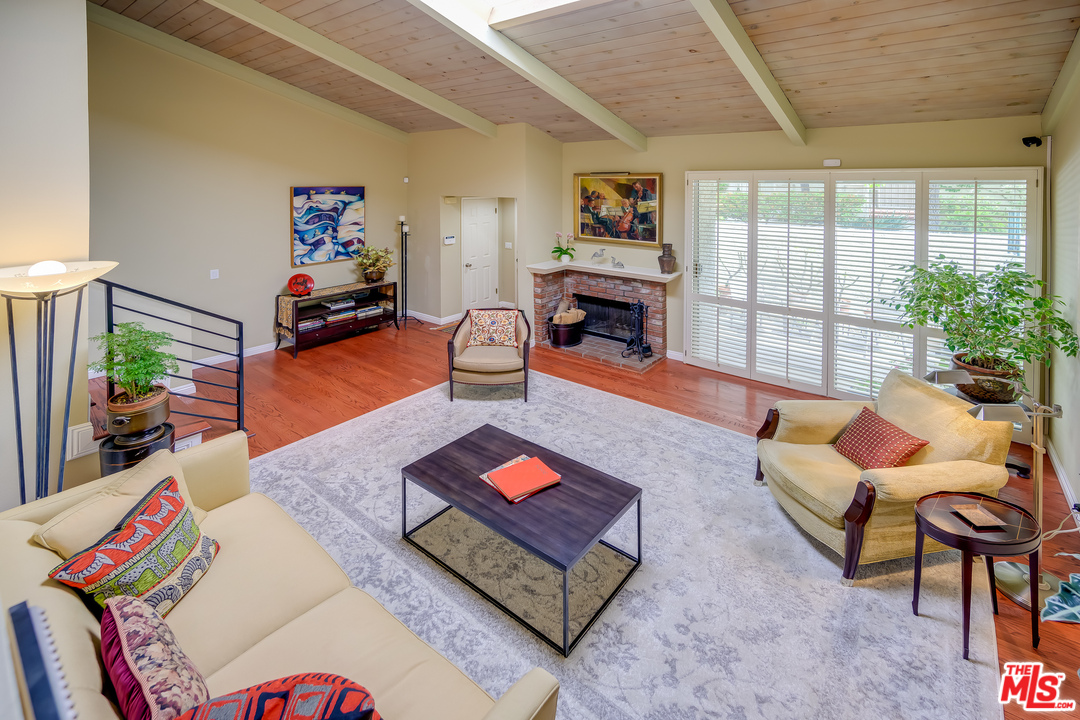 a living room with furniture a rug and a large window