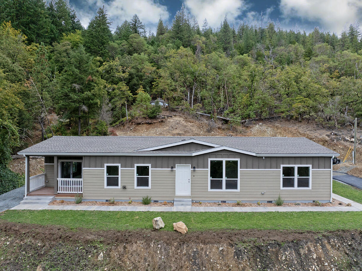 5572 Jumpoff Joe Creek Road Grants Pass, OR 97526 - Photo 1 of 38 a front view of a house with a yard and garage