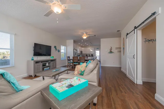a living room with furniture and wooden floor