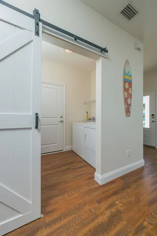 a view of a dining room with furniture and wooden floor