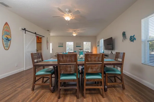 a kitchen with wooden floors and white appliances
