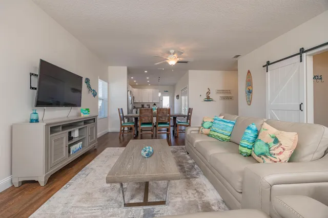 a living room with furniture and a flat screen tv