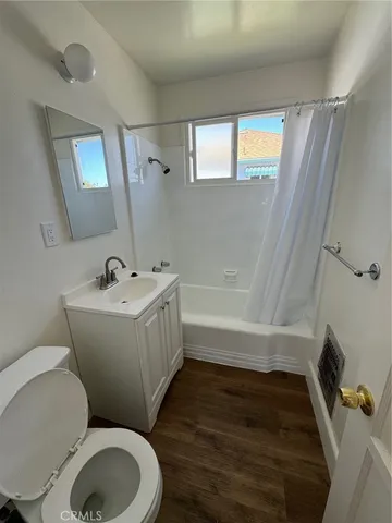 a bathroom with a sink mirror bathtub and toilet
