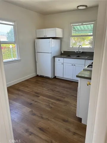 a kitchen with a refrigerator sink and a window