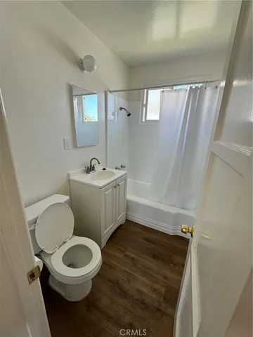 a bathroom with a sink mirror toilet and shower