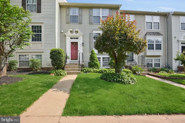 a front view of a house with a yard and outdoor seating