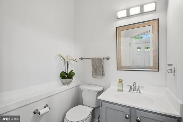 a bathroom with a toilet sink and mirror