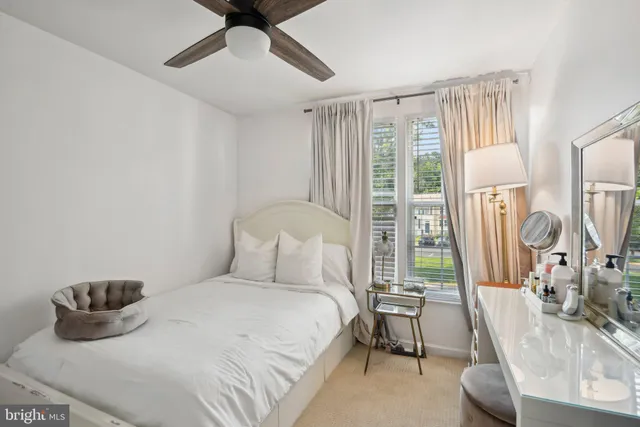 a bedroom with a bed and a large window