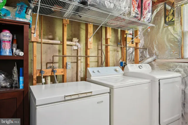 a view of washer and dryer with kitchen view