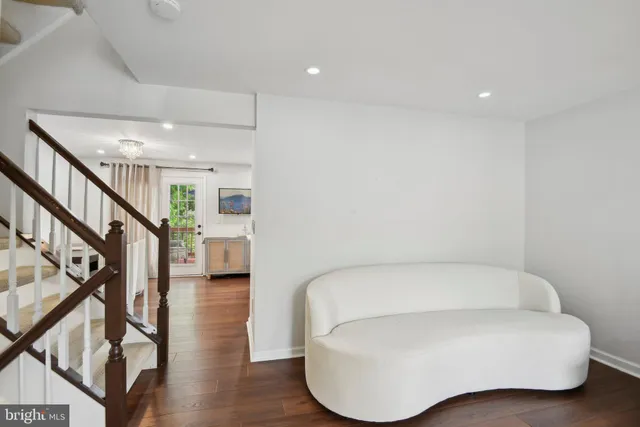 a living room with furniture and stairs