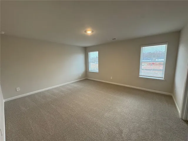 a spacious bathroom with double vanity and a mirror