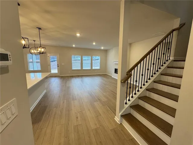 a view of a room with wooden floor and staircase
