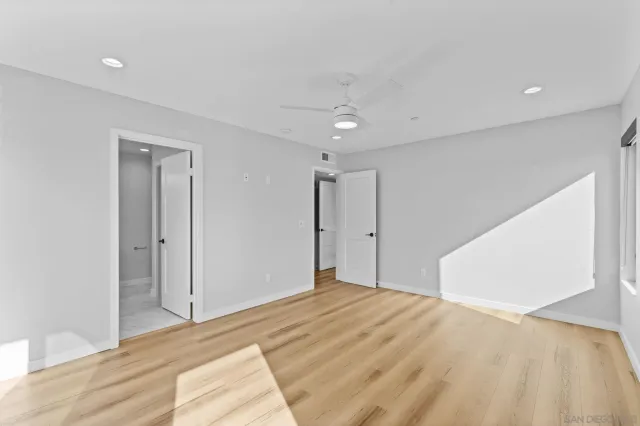 a bedroom with a bed and a painting on the wall