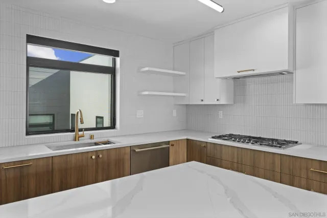 a kitchen with granite countertop a sink and cabinets